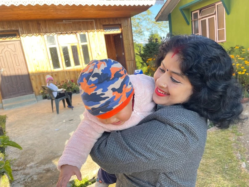 Basana Saha playing with a baby