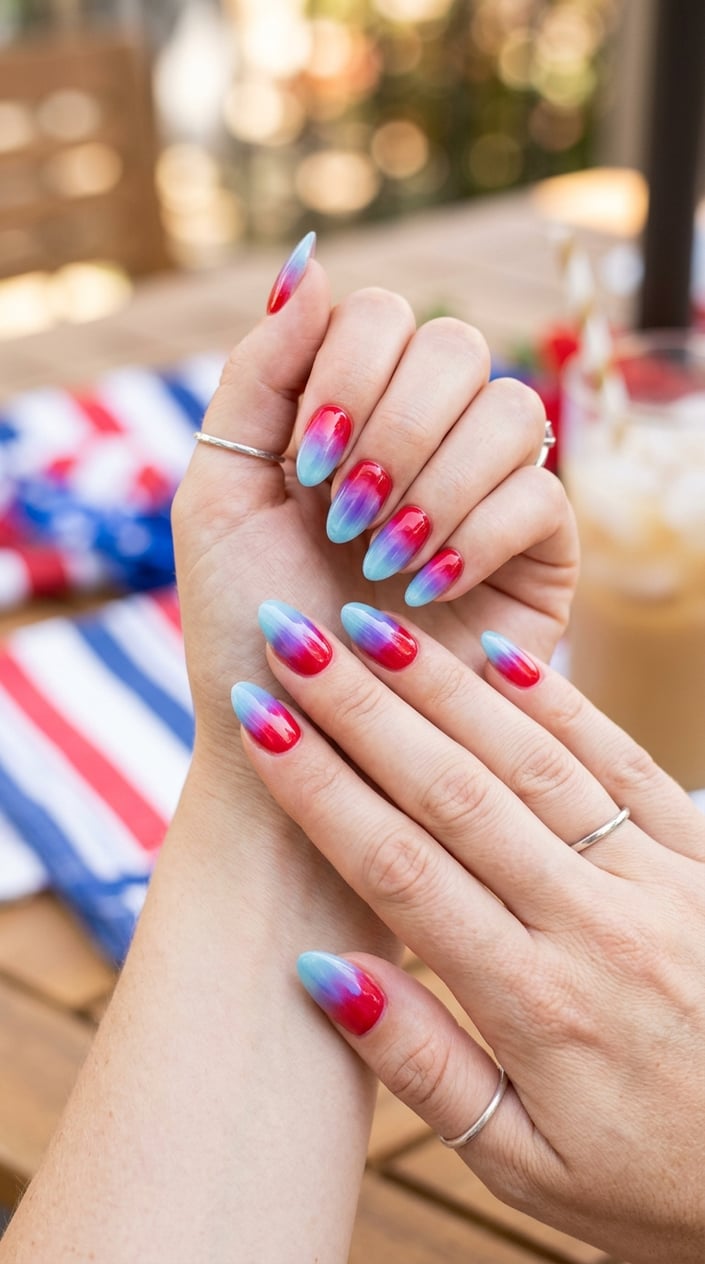 Close-up of hands with cherry red and ice blue popsicle-inspired nails holding a festive background.